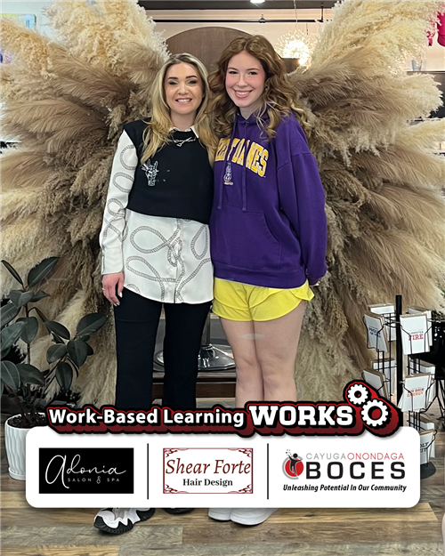 Emme Weed and her mentor standing at the front of a salon posing and smiling for a photo.  